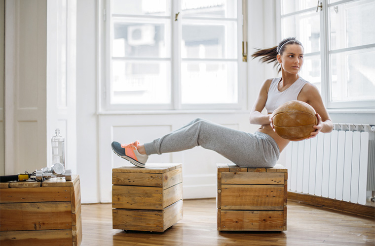 Stocksy-studio-firma-woman-working-out-with-medicine-ball